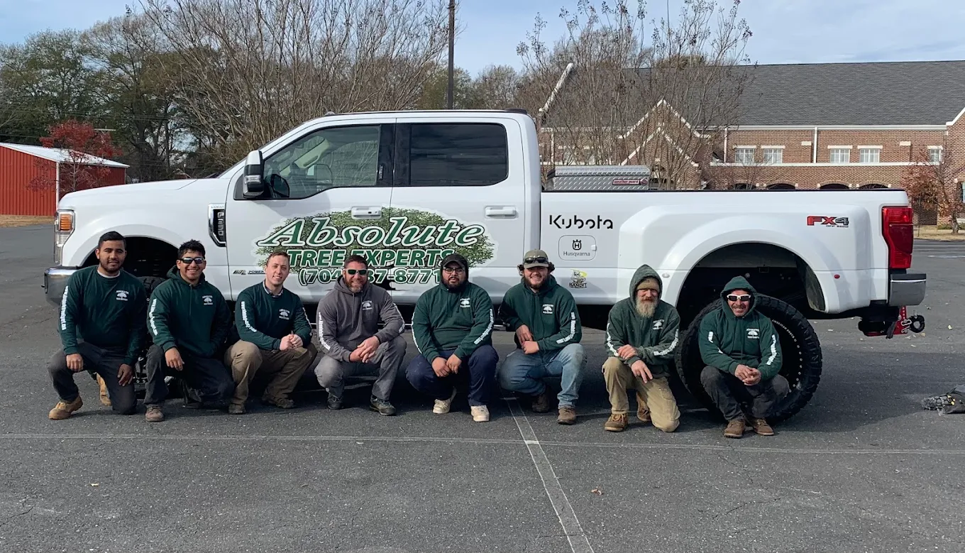 Team standing in front of company truck
